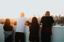 Young people looking over a wall